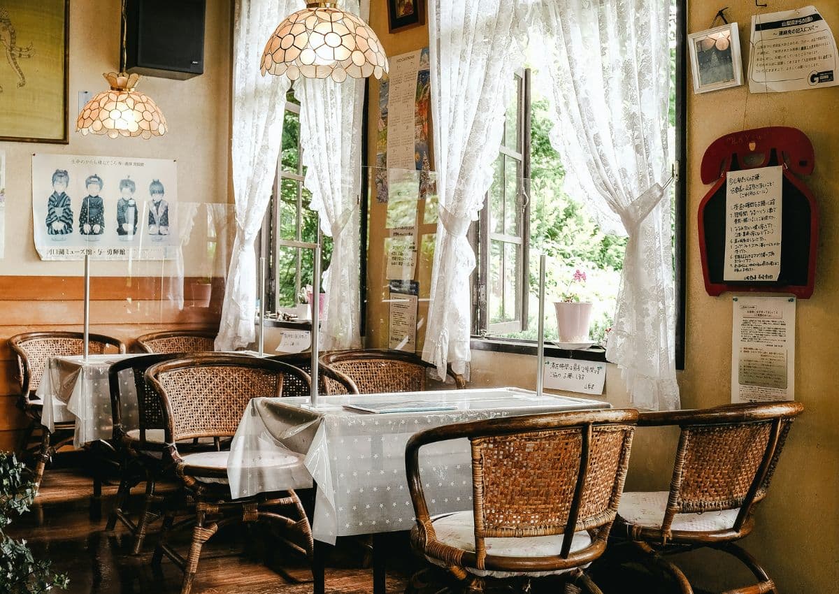 Kissaten tables and chairs with glass lights and lace textiles, Japan