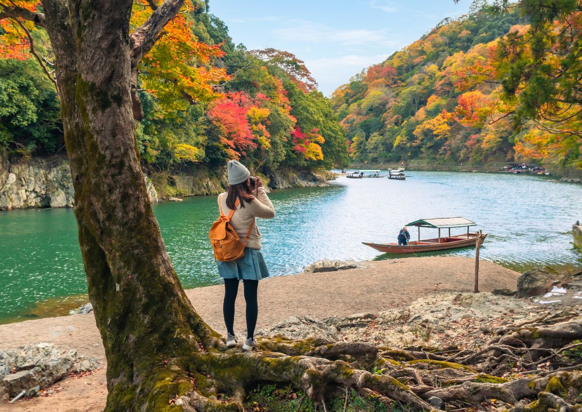 Traveller looking at Arashiyama in autumn, Kyoto, Japan