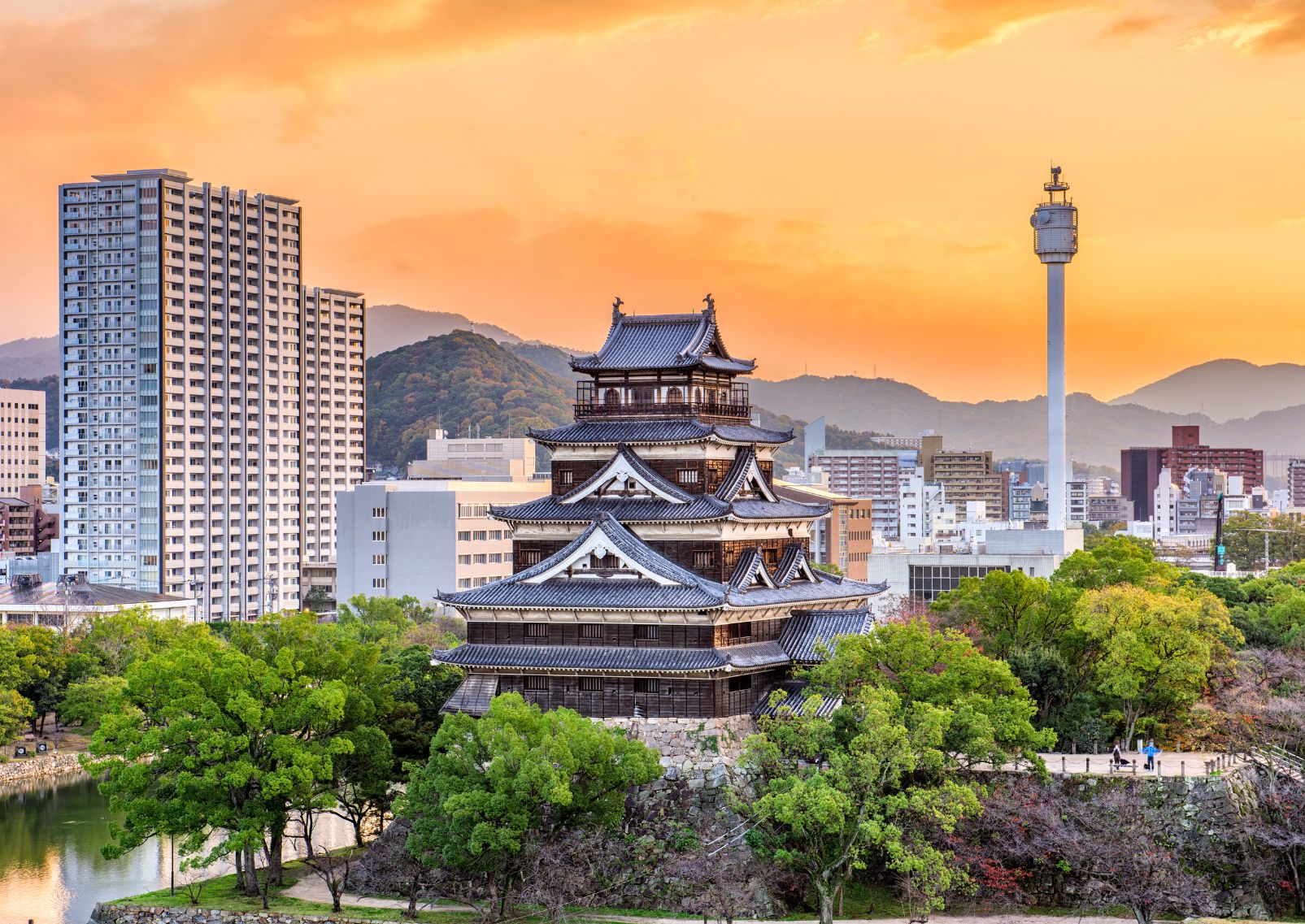 The brown and white wooden Hiroshima Castle on a sunny day in autumn