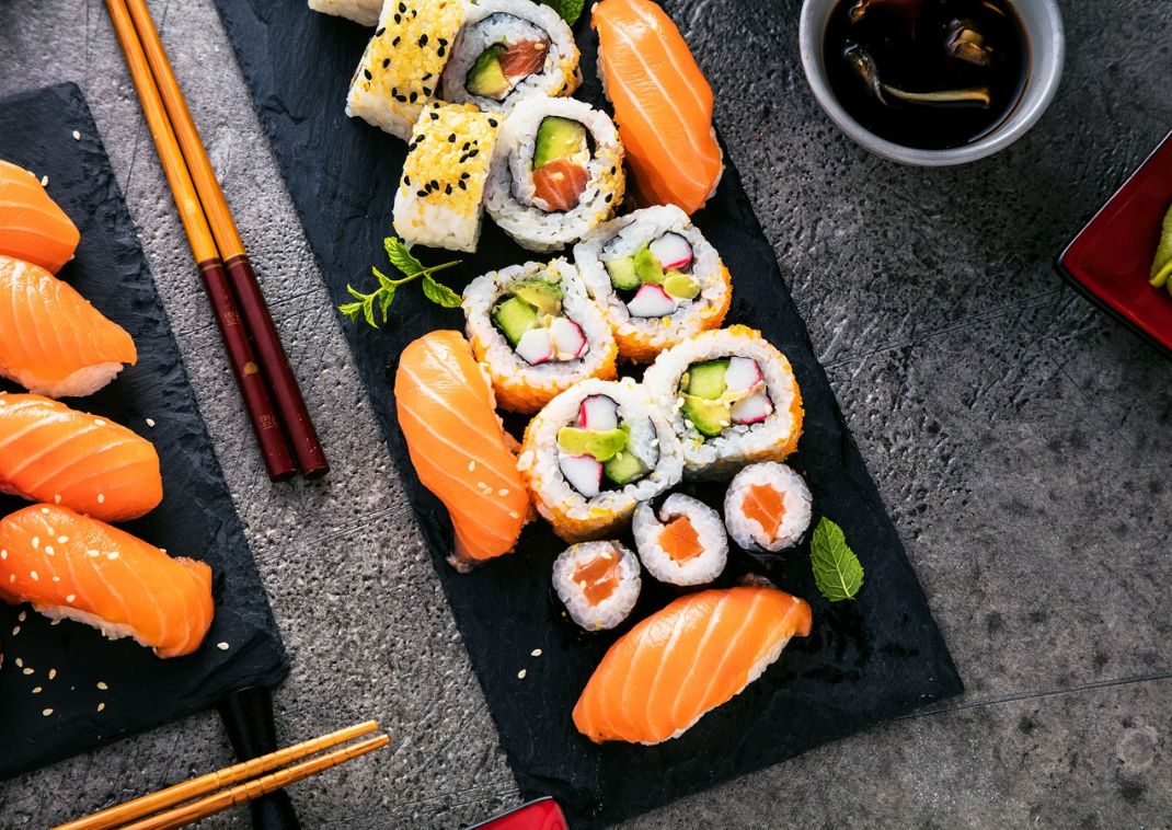 Japanese sushi with avocado and salmon, served with soy sauce