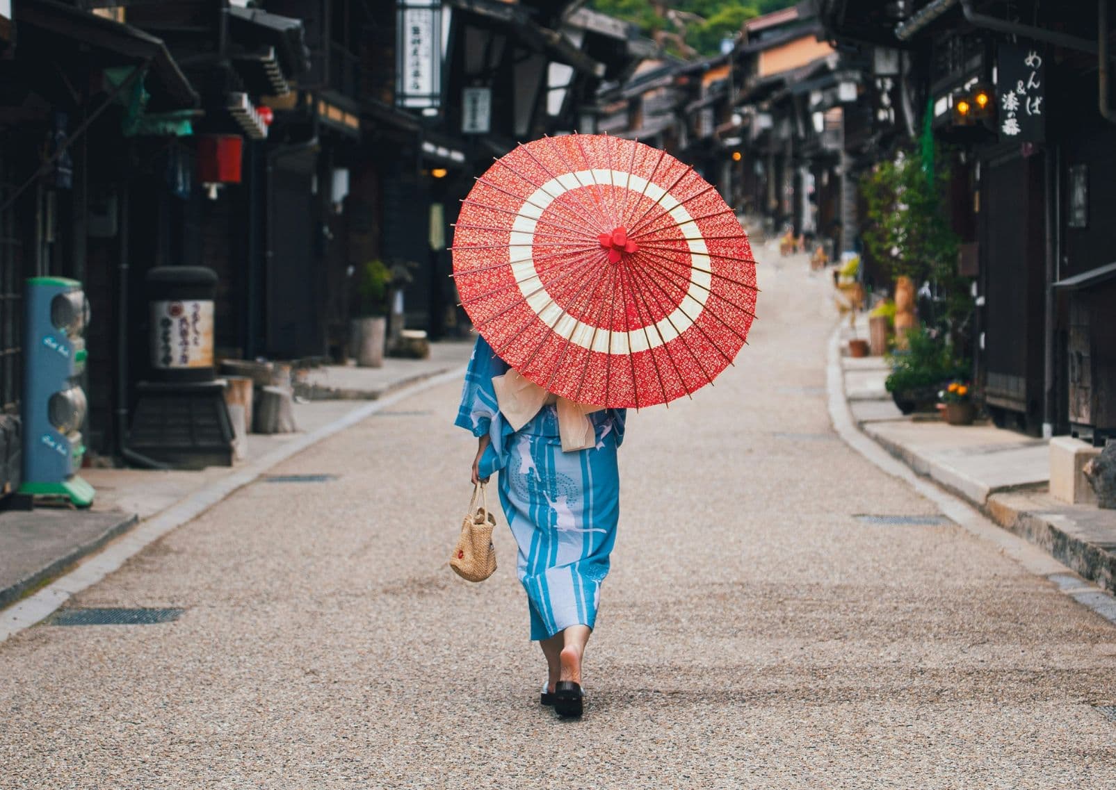 Woman in kimono holding a wagasa walking in Narai-juku, Japan