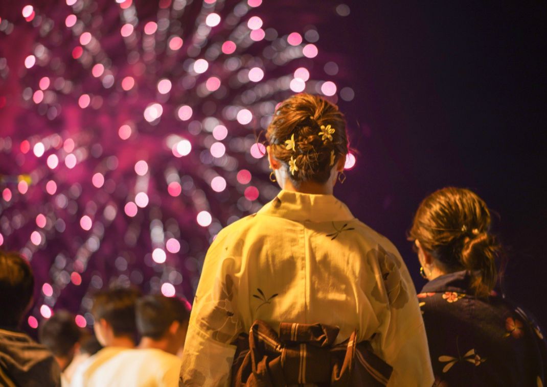 Women in yukata watching fireworks in summer