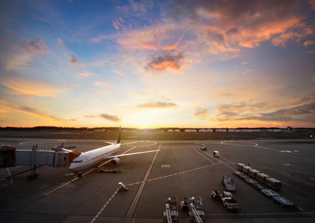 Airplane at sunset on runway in airport