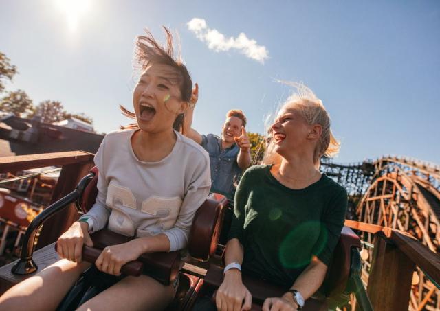 Young people having fun on a fast-paced roller coaster