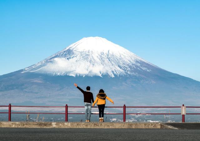 Couple standing in front of Mt. Fuji by themselves  