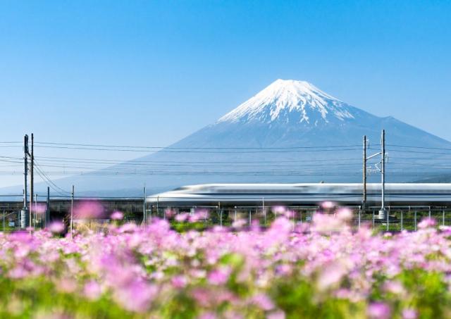 shinkansen bullet train passing by mount