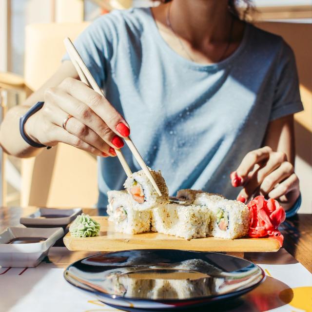 Lady eating gluten free sushi in Japan