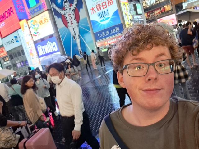 Selfie amidst the vibrant hustle and bustle of Dotonbori, Osaka
