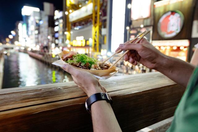 Eating takoyaki in Osaka