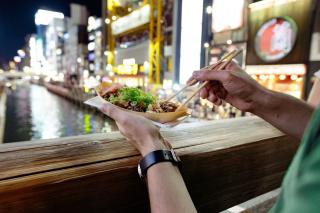 Eating takoyaki in Osaka