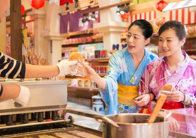 Tourists in Japan buying street food