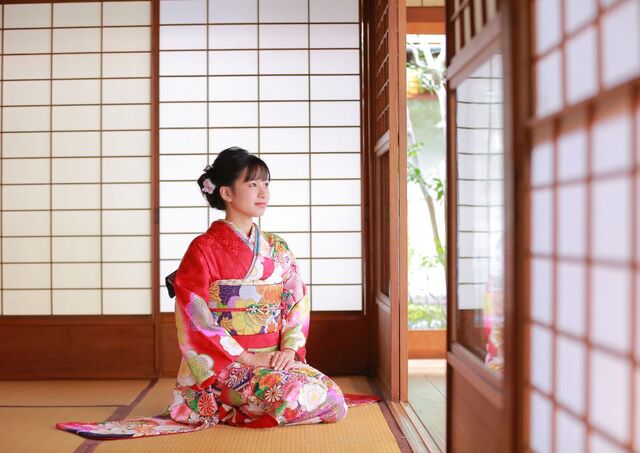 Young woman in kimono in a traditional Japanese room