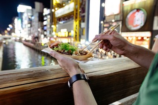 Eating takoyaki in Osaka