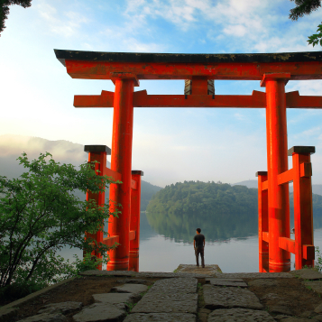 Tourist at the red torii gate of Hakone Shrine, located on Lake Ashi, Japan