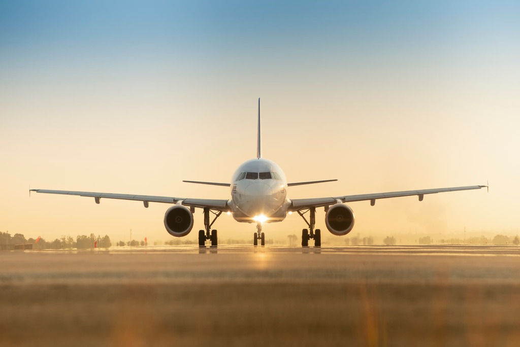 Sunset view of airplane on Japanese airport runway under dramatic sky