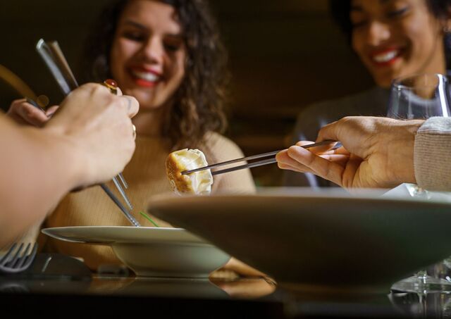 Diners sharing gyoza at dinner in Japan