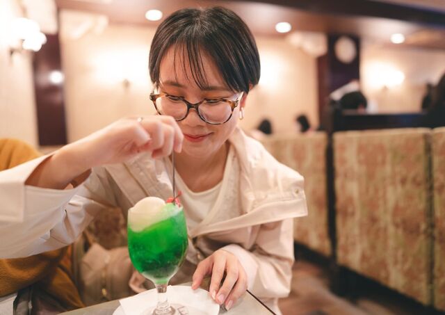 Girl enjoying cream soda in a Japanese retro kissaten