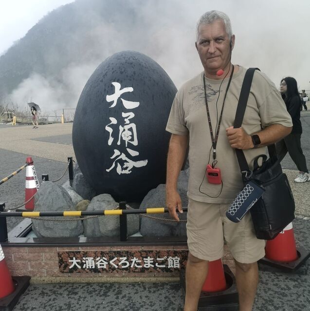Beside a black egg-shaped monument in Owakudani, Hakone 