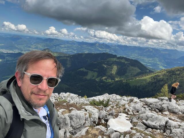 On an Alpine summit with panoramic views over the valley 