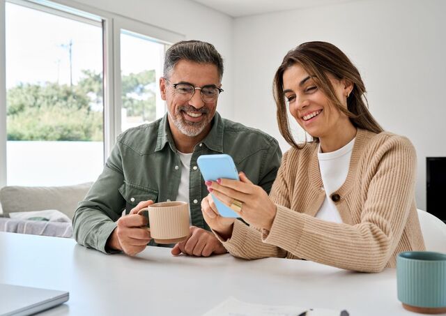 Middle-aged man and woman holding smarphones
