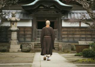 A monk in the courtyard of a monastery in Kamakura