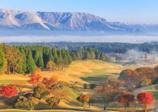 Visitors can play golf under Mount Aso