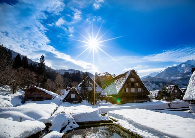 Traditional style huts of Shirakawa-go and Gokayama, view of the sunset, Japan, Winter
