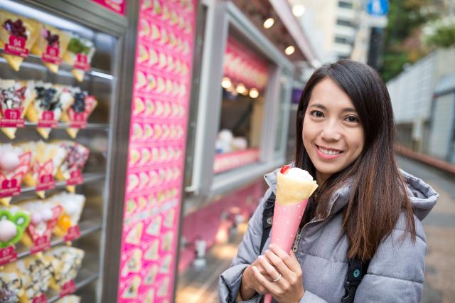 Woman eating a crepe