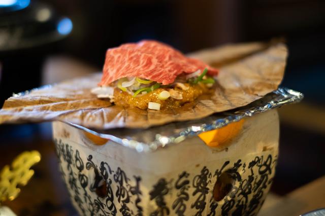 Charcoal grilled hida beef on oba leaf with miso and vegetables